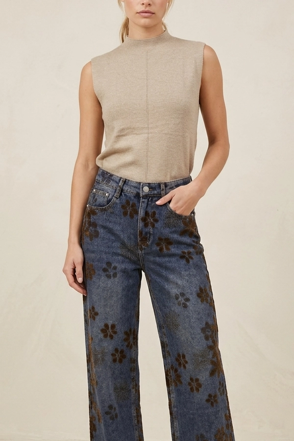 Woman wearing beige ribbed knit top with wide leg jeans