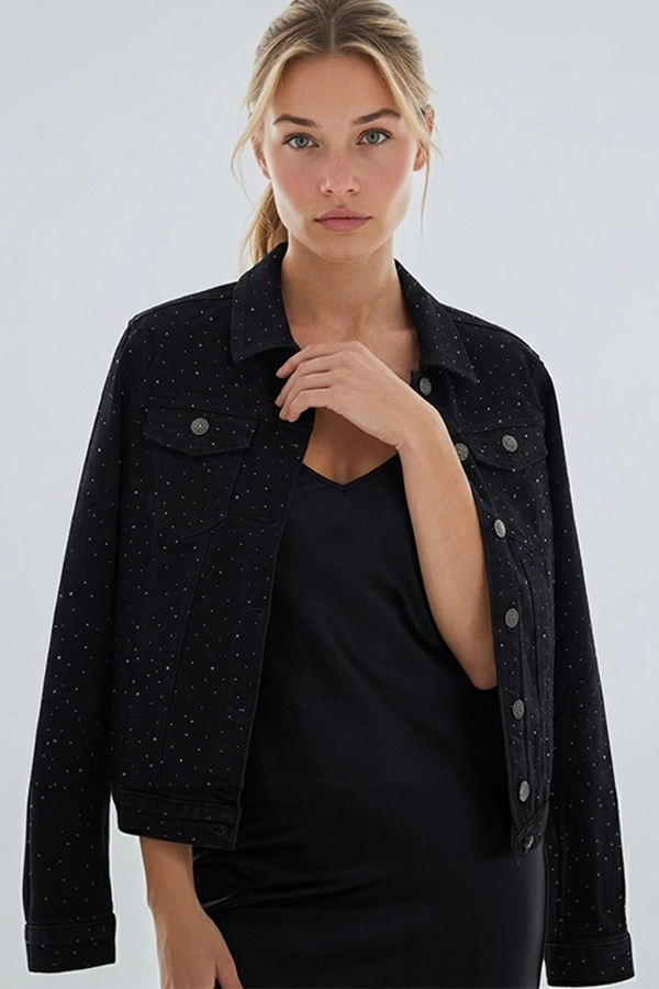 Woman wearing black rhinestone denim jacket with sparkling details