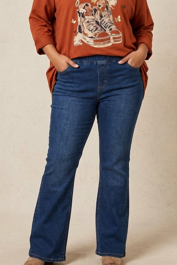 Plus size woman wearing high waist dark wash flare jeans