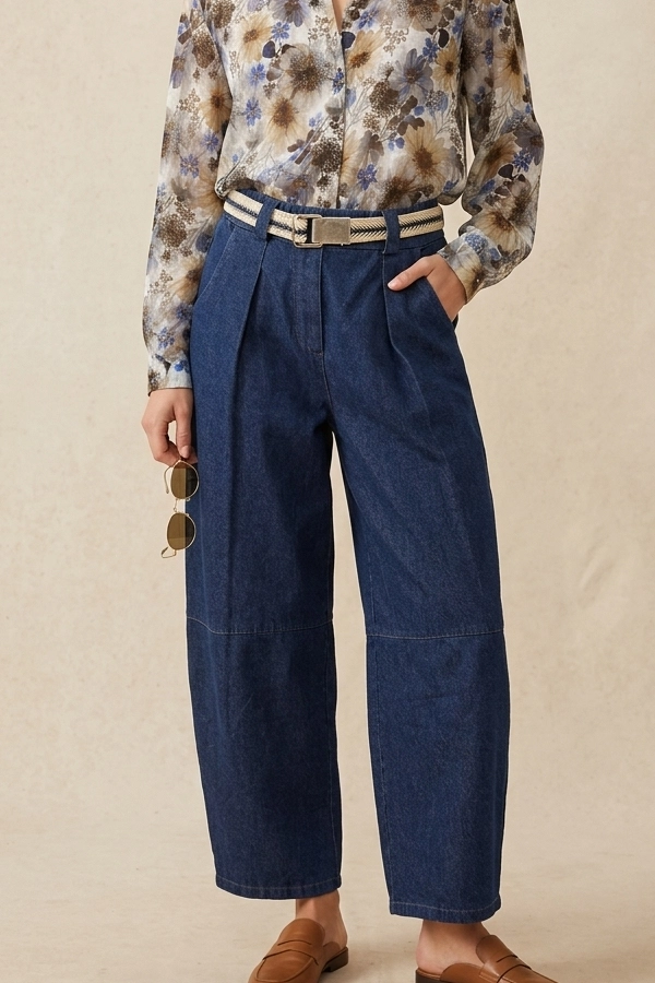 Woman wearing women's barrel fit jeans with floral shirt and woven belt