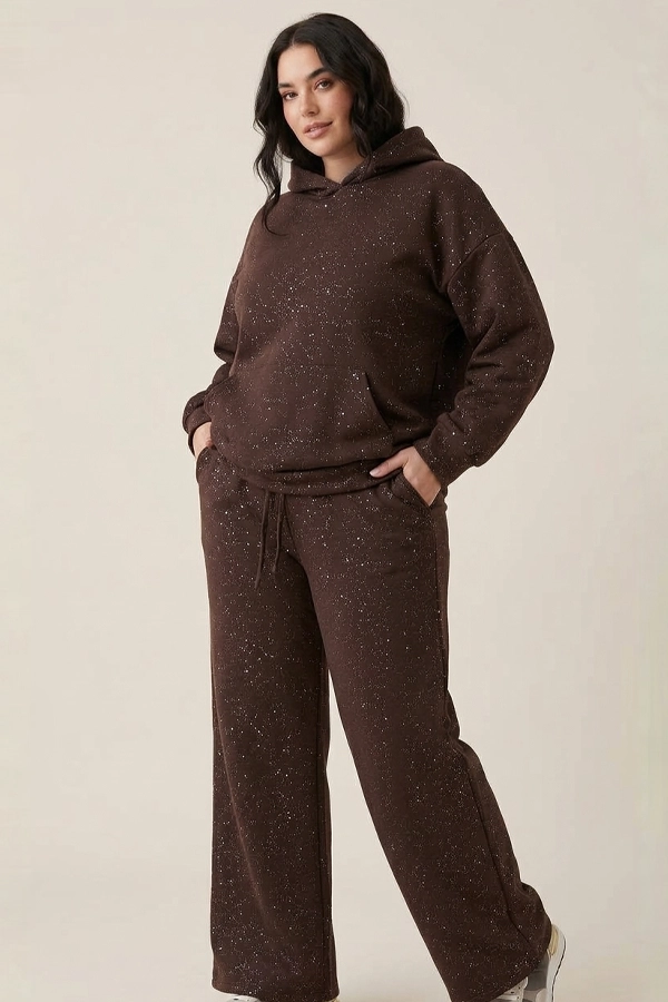 Woman wearing brown oversized glitter hoodie with wide-leg joggers
