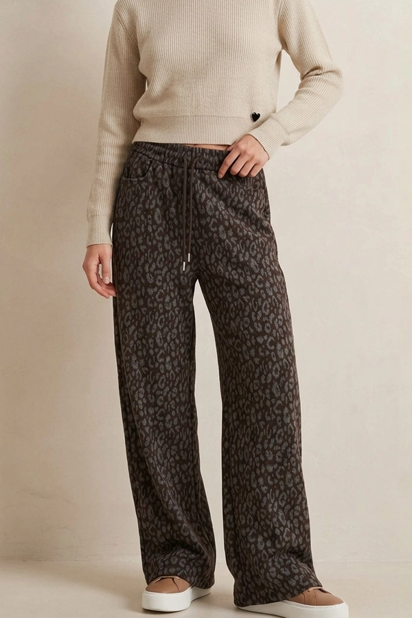 Woman wearing brown cotton animal print wide-leg trousers
