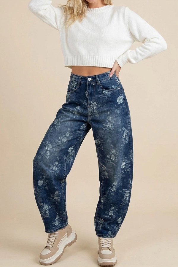 Woman wearing blue floral jacquard balloon jeans with a white cropped sweater