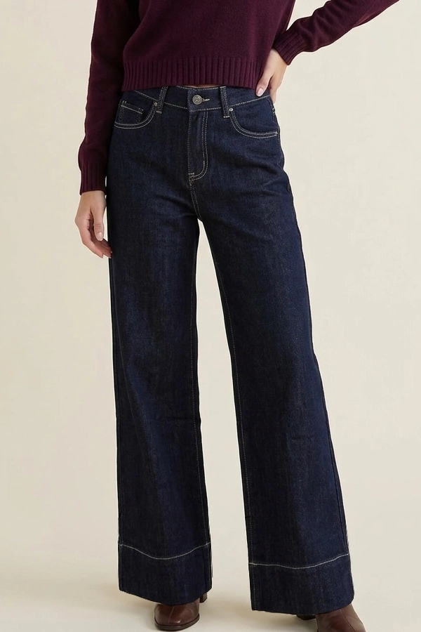 Woman wearing high waist wide leg dark blue jeans
