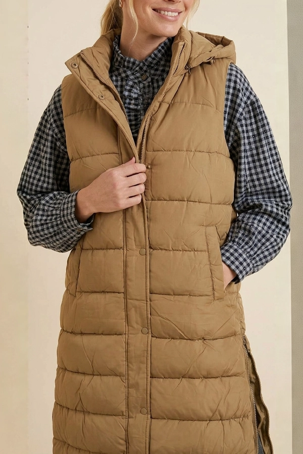 Full front view of beige long padded vest with hood and front pockets