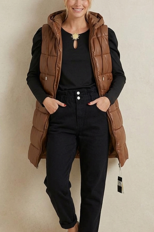 Woman wearing a long brown eco-leather puffer vest with hood