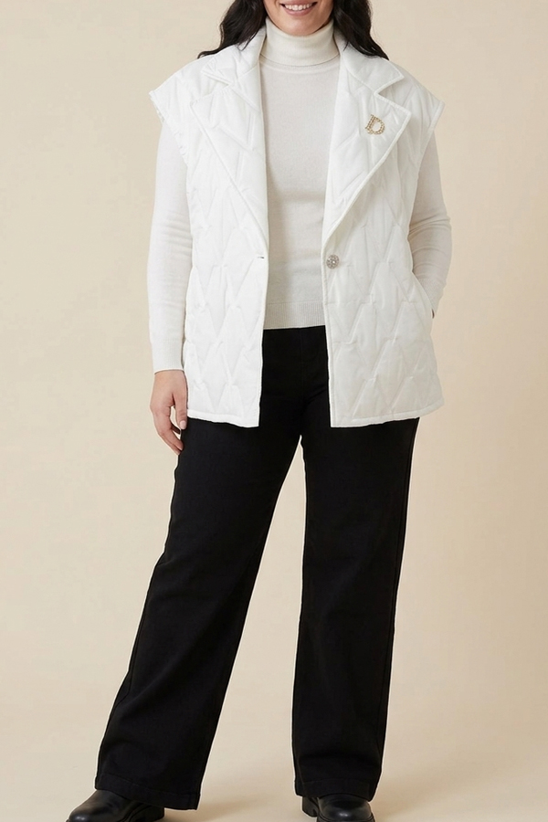 Plus size model wearing black high-waist wide-leg jeans with a white turtleneck and quilted vest